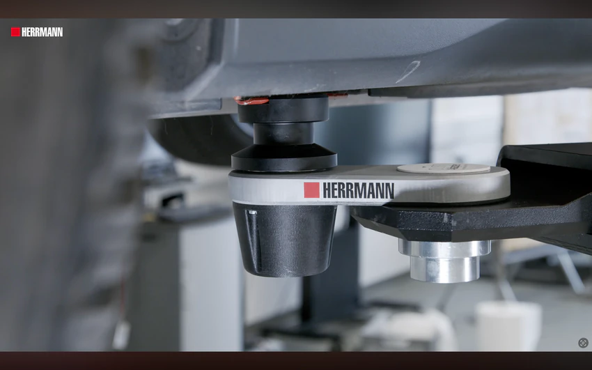 Der HERRMANN pushAdapter im Einsatz unter einem Fahrzeug, Filmstill aus dem Werbe- und Erklärfilm.